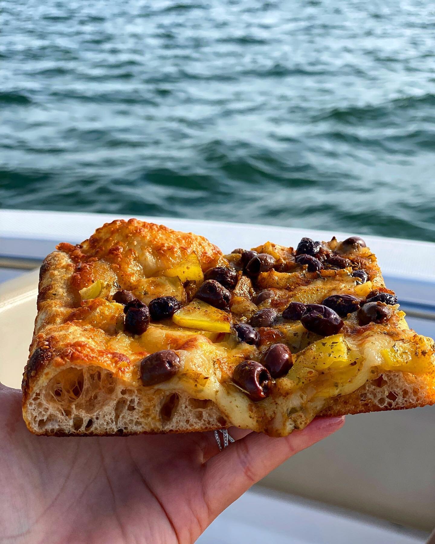 That&rsquo;s our special this week, it&rsquo;s got spiced olives, potatoes and mozzarella. This one is being enjoyed on the Atlantic Ocean but you can take yours wherever you want. Quantities are limited, order by the piece. 
#radicimeansroots #port